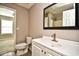 Bathroom with a white sink vanity, framed mirror, and toilet at 3506 Evergreen Way # 3506, Myrtle Beach, SC 29577