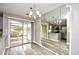 Open dining area leading to a screened porch, featuring a mirrored wall and views of the modern kitchen at 3506 Evergreen Way # 3506, Myrtle Beach, SC 29577