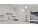 Bright kitchen with modern appliances, white cabinetry, and quartz countertops at 4161 Hibiscus Dr. # 15-302, Little River, SC 29566