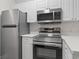 Stainless steel appliances including refrigerator, range, and microwave in the kitchen at 4161 Hibiscus Dr. # 15-302, Little River, SC 29566