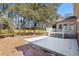 Large backyard featuring a wooden deck, brick patio, and lush landscaping at 4350 Goude St., Murrells Inlet, SC 29576