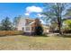 Exterior of home shows a brick chimney, fenced yard, and deck area in the backyard at 4350 Goude St., Murrells Inlet, SC 29576