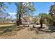 A nicely landscaped backyard features a brick patio, mature trees, and a well-maintained lawn at 4350 Goude St., Murrells Inlet, SC 29576