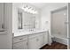 This bathroom features a double sink vanity with white cabinets, a large mirror, and a separate shower/tub area at 4350 Goude St., Murrells Inlet, SC 29576