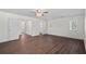 A bright bedroom with wood flooring, multiple windows, and access to an en-suite bathroom at 4350 Goude St., Murrells Inlet, SC 29576