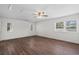 This well-lit bedroom has two windows, a ceiling fan and attractive wood laminate floors at 4350 Goude St., Murrells Inlet, SC 29576