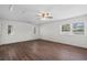 Bright bedroom features wood floors, a ceiling fan and natural light from three windows at 4350 Goude St., Murrells Inlet, SC 29576