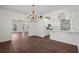 Elegant dining room featuring hardwood floors, modern lighting, and a view of the updated kitchen at 4350 Goude St., Murrells Inlet, SC 29576