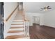 Welcoming entryway showcases stairs with wood and white accents, leading to a spacious living area with new floors at 4350 Goude St., Murrells Inlet, SC 29576