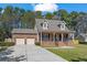 Charming brick home featuring a two-car garage, dormer windows, and a cozy front porch at 4350 Goude St., Murrells Inlet, SC 29576