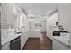 Open kitchen design with a center island, white cabinets, and modern fixtures at 4350 Goude St., Murrells Inlet, SC 29576