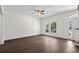 Bright living room with wood-look floors, large windows, ceiling fan, and neutral tones throughout at 4350 Goude St., Murrells Inlet, SC 29576