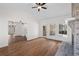 Spacious living room with a brick fireplace, ceiling fan, and large windows at 4350 Goude St., Murrells Inlet, SC 29576