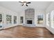 Spacious living room with a brick fireplace, ceiling fan, and large windows at 4350 Goude St., Murrells Inlet, SC 29576