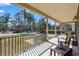 Inviting covered porch with black railings, ceiling fan, and seating area offers a relaxing outdoor space at 4350 Goude St., Murrells Inlet, SC 29576