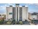 Exterior aerial view of the beachside condo building with palm trees and ocean in the background at 4505 South Ocean Blvd. # 8-D, North Myrtle Beach, SC 29582