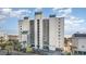 Exterior aerial view of the beachside condo building with palm trees and ocean in the background at 4505 South Ocean Blvd. # 8-D, North Myrtle Beach, SC 29582