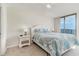 Inviting bedroom with a decorative bedspread, nightstands with lamps, and a sliding door for natural light at 4505 South Ocean Blvd. # 8-D, North Myrtle Beach, SC 29582