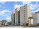 Multi-story condo with balconies, green roof accents, and tropical landscaping at 4505 South Ocean Blvd. # 8-D, North Myrtle Beach, SC 29582