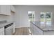 Kitchen island featuring granite countertops, stainless steel dishwasher and white cabinets at 491 Wagner Cir., Conway, SC 29526