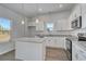 Well-lit kitchen featuring an island, stainless steel appliances, granite countertops, and white cabinetry at 491 Wagner Cir., Conway, SC 29526