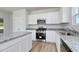 Beautiful kitchen boasts granite countertops, stainless steel appliances, and white cabinets at 491 Wagner Cir., Conway, SC 29526