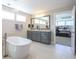 Modern bathroom with a freestanding tub, double vanity with granite countertop, and view into the bedroom at 511 Rose Fountain Dr., Myrtle Beach, SC 29579