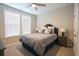 Bright bedroom featuring two windows, a ceiling fan, and dark blue nightstands at 511 Rose Fountain Dr., Myrtle Beach, SC 29579