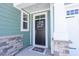 Inviting entrance with a 'beach' wreath, decorative columns, and stylish stone accents on the facade at 511 Rose Fountain Dr., Myrtle Beach, SC 29579