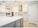 Well-lit kitchen featuring white cabinetry, quartz countertops, and stainless steel appliances at 511 Rose Fountain Dr., Myrtle Beach, SC 29579