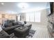 Bright living room with natural light, a large gray sectional, and an open view to the kitchen at 511 Rose Fountain Dr., Myrtle Beach, SC 29579