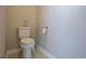 Simple and clean powder room with a white toilet and neutral paint for a minimalist design at 511 Rose Fountain Dr., Myrtle Beach, SC 29579