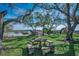 Idyllic backyard view featuring mature trees, an outdoor dining set, and a wooden walkway along the water at 5137 Highway 17 Business # 3A, Murrells Inlet, SC 29576