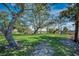 Beautiful backyard with a round stone picnic table, lush green grass, and an expansive view of the surrounding marsh at 5137 Highway 17 Business # 3A, Murrells Inlet, SC 29576