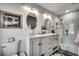 Bright bathroom featuring a double vanity, stylish mirrors, and a glass-enclosed shower at 5137 Highway 17 Business # 3A, Murrells Inlet, SC 29576