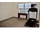 This bedroom features a treadmill, desk, and natural light at 517 Brooksher Dr., Myrtle Beach, SC 29588