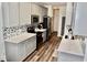 This kitchen features light gray cabinets, stainless steel appliances and wood-look floors at 517 Brooksher Dr., Myrtle Beach, SC 29588