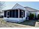 Backyard view of a screened in porch for outdoor living and entertaining at 517 Brooksher Dr., Myrtle Beach, SC 29588