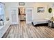 Bright sunroom with wood-look flooring and seamless access to another living space at 517 Brooksher Dr., Myrtle Beach, SC 29588