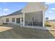 Exterior view of home featuring a screened patio and spacious backyard at 547 Bucks Trail, Longs, SC 29568