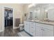 Bathroom featuring double vanity with granite counters, closet, decorative mirror, and a shower at 547 Bucks Trail, Longs, SC 29568