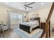 Bedroom with a king bed, ceiling fan, area rug and a sunny window with nice curtains at 547 Bucks Trail, Longs, SC 29568