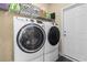 Modern laundry room featuring front load washer and dryer with storage at 547 Bucks Trail, Longs, SC 29568