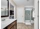 Bright bathroom featuring double vanity, walk-in closet, and a modern glass-enclosed shower at 5572 Redleaf Rose Dr., Myrtle Beach, SC 29579