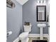 Charming powder room featuring a pedestal sink, framed mirror, and decorative elements at 5572 Redleaf Rose Dr., Myrtle Beach, SC 29579