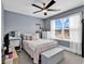 Bright bedroom with a double bed, white furniture, ceiling fan, and a large window with scenic views at 5572 Redleaf Rose Dr., Myrtle Beach, SC 29579