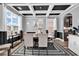 Elegant dining room featuring coffered ceilings, hardwood floors, a modern chandelier, and black and white accents at 5572 Redleaf Rose Dr., Myrtle Beach, SC 29579