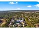 Aerial view of 611 Woodmoor Dr community nestled in a green, wooded area with central pond and pool at 611 Woodmoor Dr. # 301, Murrells Inlet, SC 29576