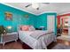 Bright bedroom with turquoise walls, decorative accents, and a cozy, inviting bed at 611 Woodmoor Dr. # 301, Murrells Inlet, SC 29576