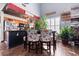 Cozy dining area with floral upholstered chairs, wooden floors and a modern light fixture at 611 Woodmoor Dr. # 301, Murrells Inlet, SC 29576